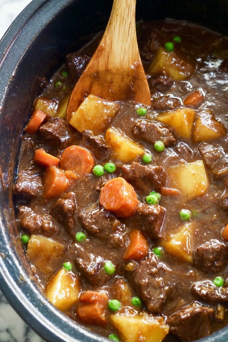 The image shows a close-up of a thick stew inside a dark pot. The stew has several layers of chunky pieces of dark brown meat mixed with soft orange carrot slices and light yellow potato chunks. Small bright green peas are scattered evenly throughout the stew, adding a pop of color. The sauce is rich and glossy, covering all the ingredients with a smooth brown texture. A wooden spoon rests inside the stew, partially submerged and coated in the sauce, stirring the mixture. The background surface is white marble. photo taken with an iphone --ar 2:3 --v 7