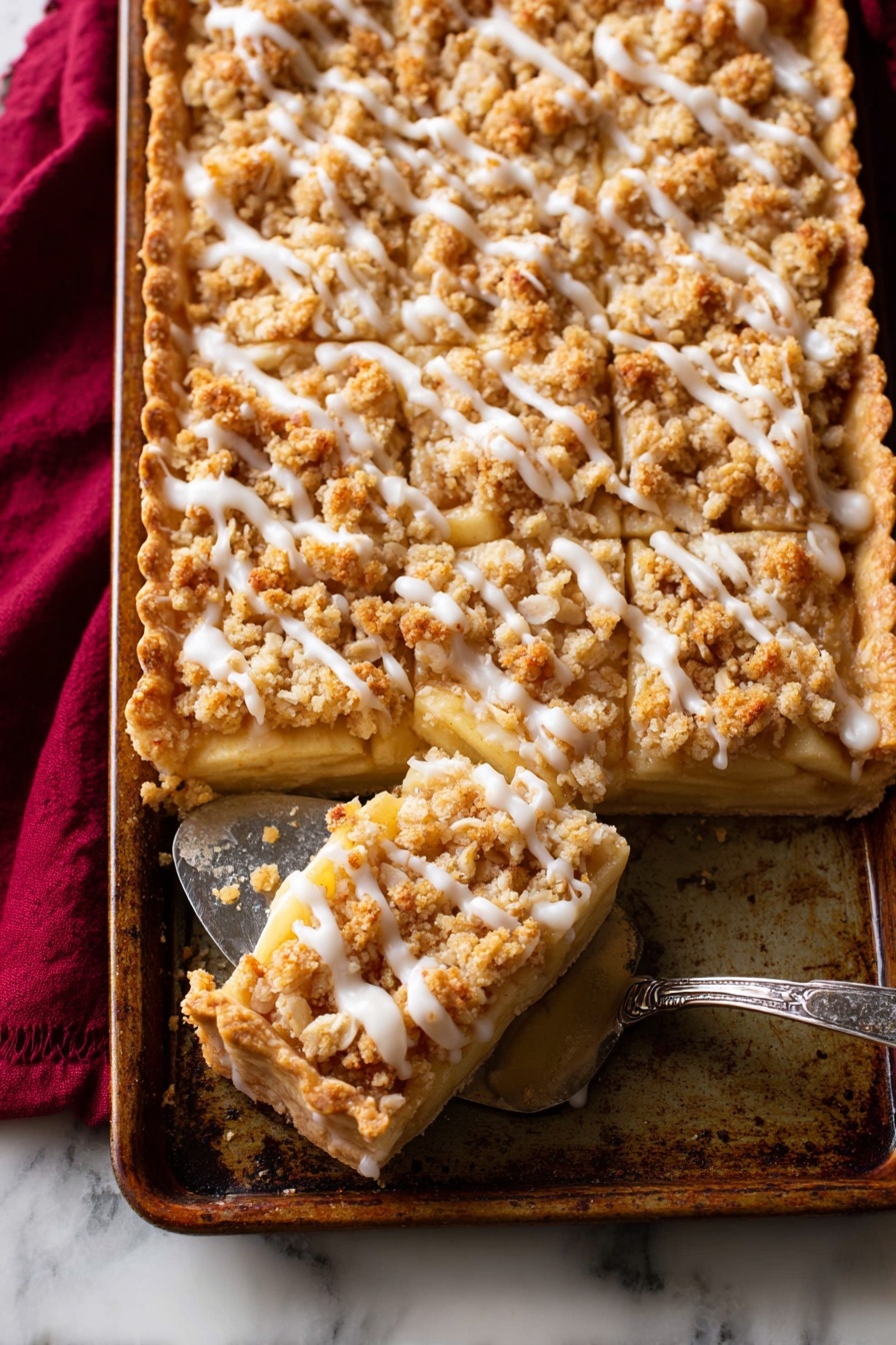 A rectangular pie with a golden-brown crust forms the bottom layer, topped by a thick layer of cooked apple slices with soft yellow and light tan colors. Above the apple layer, there is a crumbly topping made of golden oat clusters and streusel, sprinkled evenly across the surface. Drizzled on top is a thin white glaze in irregular lines. The pie sits in a well-used metal pan on a white marbled surface, with a vintage silver pie server lifting out one piece from the corner. A dark red cloth is tucked under the pan on the left side. Photo taken with an iphone --ar 2:3 --v 7