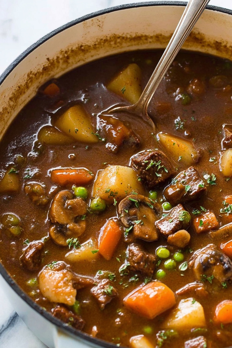 Guinness vegetable soup - The image shows a close-up of a pot filled with thick brown stew, with visible chunks of dark brown meat, light beige potatoes, orange carrots, green peas, beige mushrooms, and pieces of celery floating inside. The stew has a glossy, rich texture with some fresh green herbs sprinkled on top. A silver spoon is partially submerged in the stew, resting near the edge of the pot, which has a white exterior. The background is a white marbled surface. photo taken with an iphone --ar 2:3 --v 7