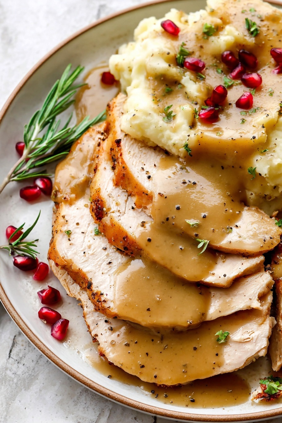 The dish shows several thick slices of cooked turkey layered on the right side of a white plate, each slice covered with smooth, light brown gravy that has small black pepper specks. On the upper left side, there is a pile of mashed potatoes topped with the same gravy, and the mashed potatoes have a creamy texture with small green herb bits sprinkled on top. Around the slices and mashed potatoes, there are small red pomegranate seeds scattered and green herb sprigs placed near the edges of the plate. The background has a soft white marbled texture. Photo taken with an iphone --ar 2:3 --v 7