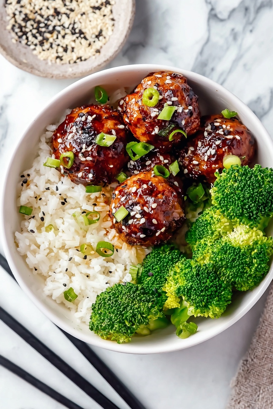 The image shows a white bowl filled with three layers: the bottom layer is white rice, the middle layer is bright green broccoli florets placed on one side, and the top layer consists of five shiny, dark brown glazed meatballs with sesame seeds and small green onion pieces sprinkled on them. The bowl sits on a light blue cloth with black chopsticks resting beside it on a white marbled surface. In the background, there is another white bowl with the same contents, and a pan with more glazed meatballs, all on the same white marbled surface. Photo taken with an iphone --ar 2:3 --v 7