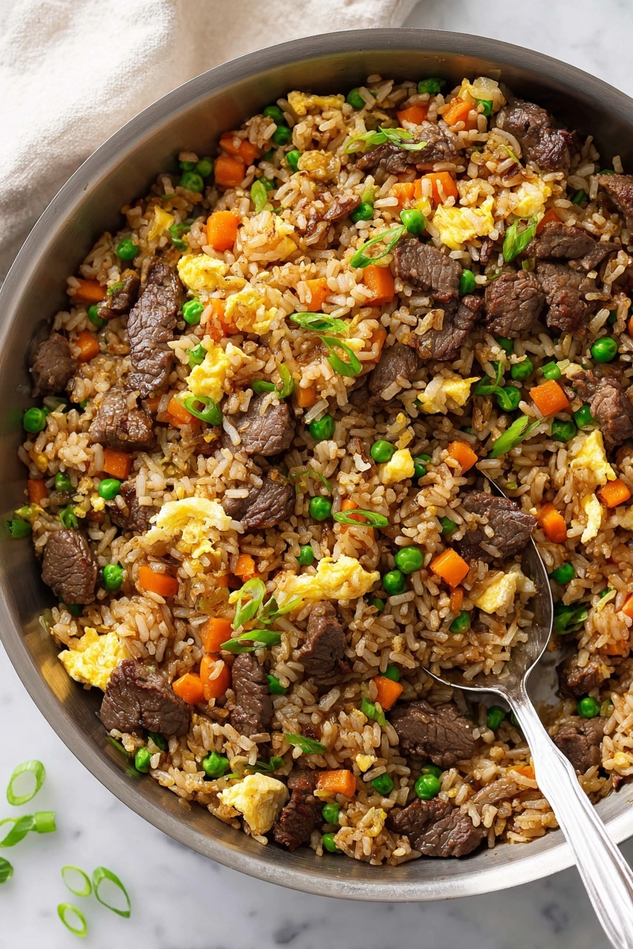 A close-up of fried rice in a silver pan with a spoon inside. The dish has four main layers: cooked brown rice, chopped orange carrots, green peas, and scrambled yellow eggs scattered throughout. There are dark brown beef pieces mixed evenly with the rice and vegetables. Some green onion slices are sprinkled on top for color. The pan sits on a white marbled surface with a light cloth in the background. Photo taken with an iphone --ar 2:3 --v 7