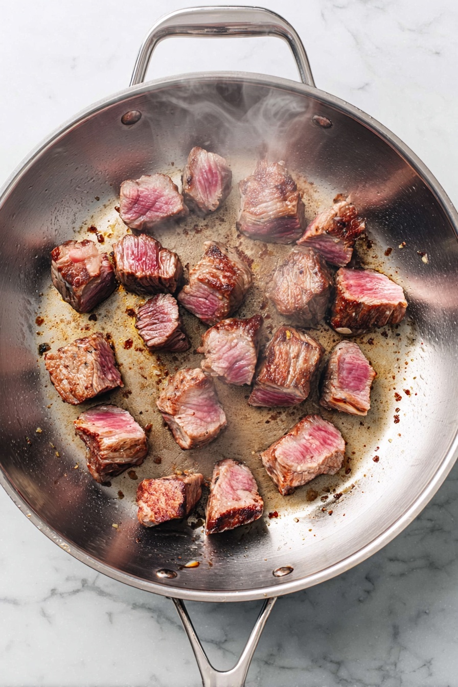 A white bowl held by a woman's hands contains a meal with three main layers. On one side, there are bright orange cooked baby carrots topped with small green parsley pieces. The middle layer is creamy white mashed potatoes with a soft and smooth texture, partially covered by a thick dark brown beef stew with visible chunks of beef in rich sauce scattered with parsley bits. The bowl rests on a white marbled surface with green parsley leaves around it. Photo taken with an iphone --ar 2:3 --v 7