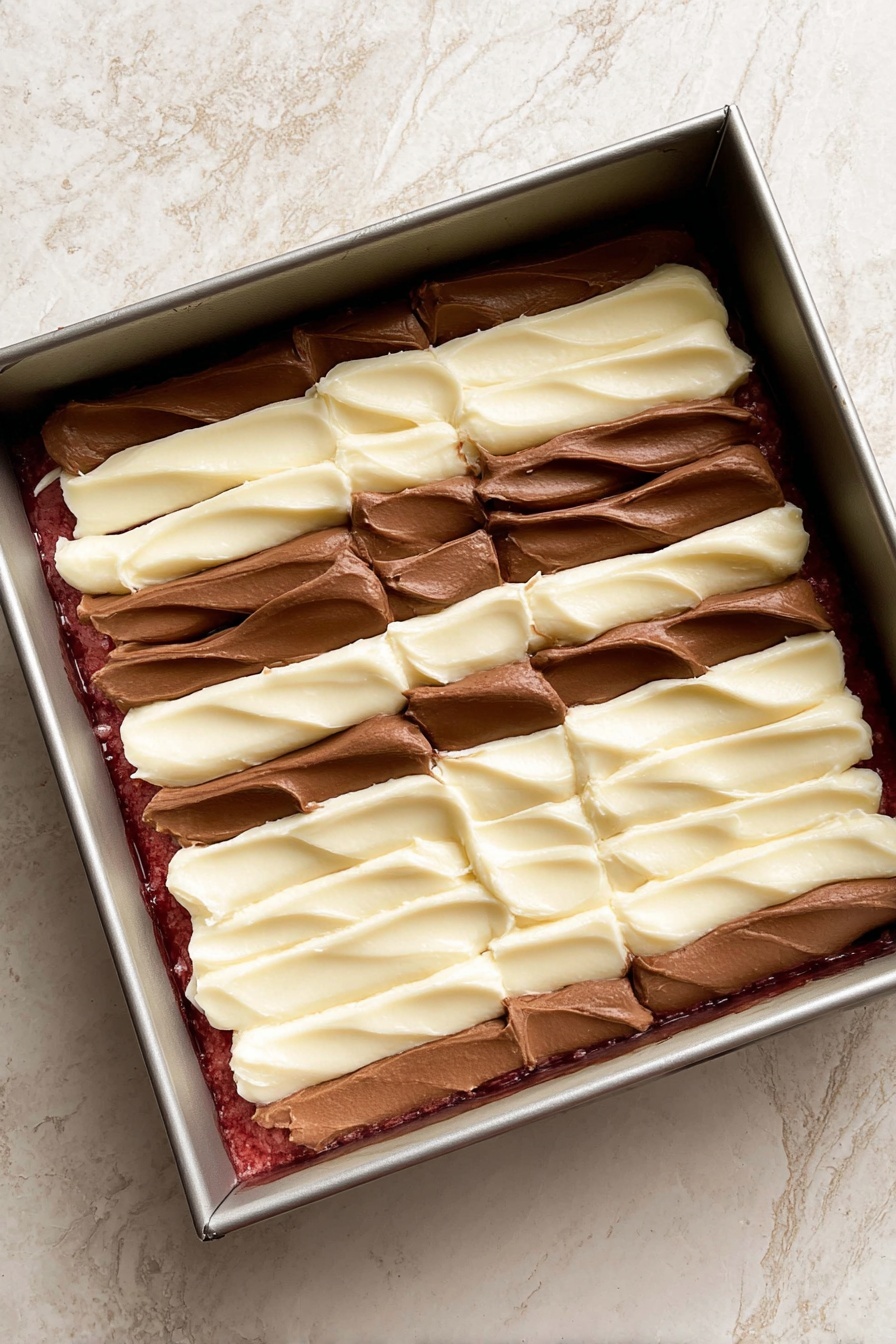 The image shows a stack of two thick pieces of dessert bars on a white marbled surface. Each bar has three visible layers: the bottom layer is dark red with a dense texture, the middle layer is creamy white with swirls of dark red, and the top layer combines dark red and creamy white in a marbled pattern with some melted chocolate spots. The bars have slightly rough edges and crumbs around them, creating a casual, homemade look. In the blurred background, more bars are visible, resting directly on the white marbled surface. Photo taken with an iphone --ar 2:3 --v 7