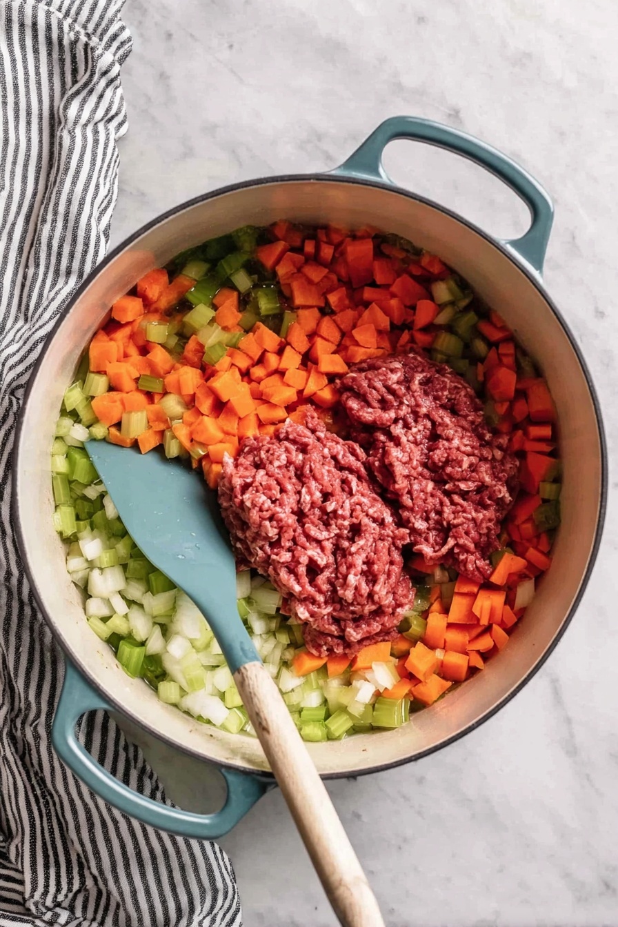 A creamy yellow soup with visible pieces of red bell pepper, ground meat, corn, and green herbs is served in a white bowl. On top of the soup, there is a generous layer of crispy brown bacon bits scattered in the center. Next to the bowl, there is a white bowl filled with more of the same soup, placed on a white marbled surface with a checked cloth partially visible underneath. The soup looks thick and smooth with a rich texture. photo taken with an iphone --ar 2:3 --v 7
