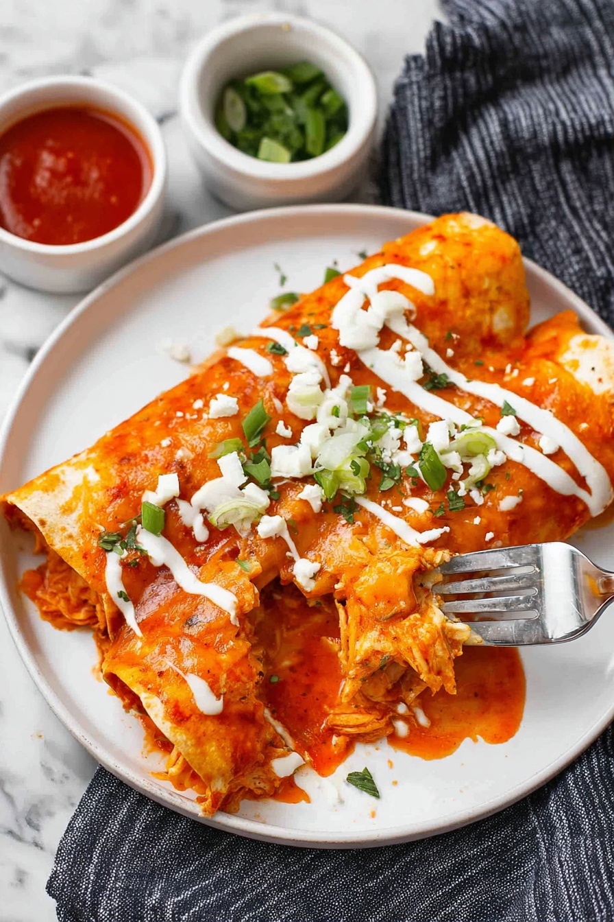 A soft, round tortilla lies flat on a white marbled surface, with a thick layer of orange creamy chicken filling spread across the lower center part of the tortilla. The filling has visible chunks of chicken mixed with red bell pepper pieces, creating a textured and rich look. The focus is on the tortilla and its filling, with no other items or distractions in the frame, photo taken with an iphone --ar 2:3 --v 7