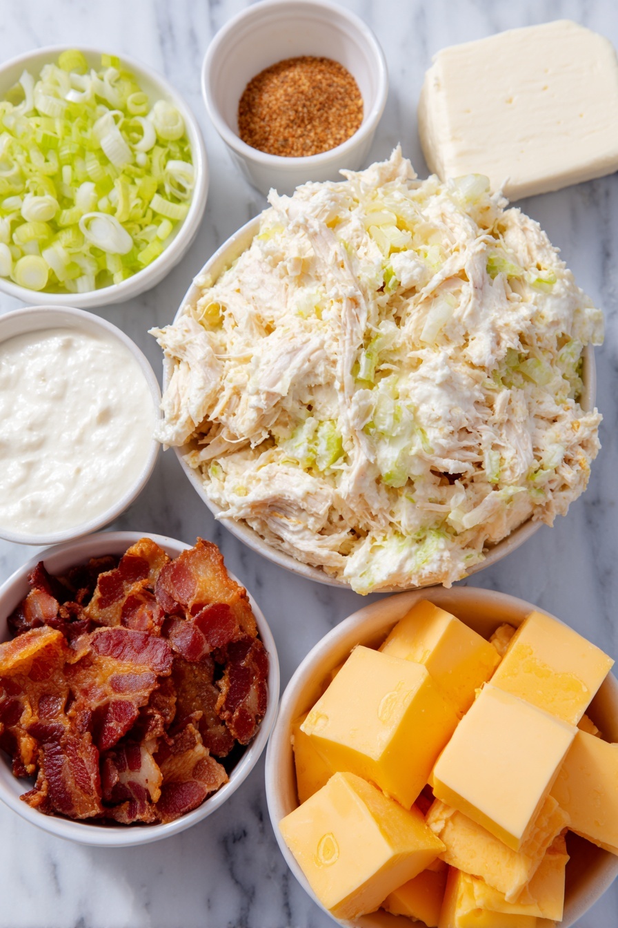 Flat lay of shredded cooked chicken, a block of cream cheese softened with a creamy texture, a small white bowl of sour cream, a small white bowl of evaporated milk, a small white bowl filled with dry ranch seasoning powder, a small white bowl of fine onion powder, crispy cooked bacon pieces, cubed Velveeta cheese with smooth yellow surfaces, chopped fresh green onions, all arranged symmetrically on a clean white marble surface, soft natural light, photo taken with an iPhone, professional food photography style, fresh ingredients, white ceramic bowls, no bottles, no duplicates, no utensils, no packaging --ar 2:3 --v 7 --p m7354615311229779997