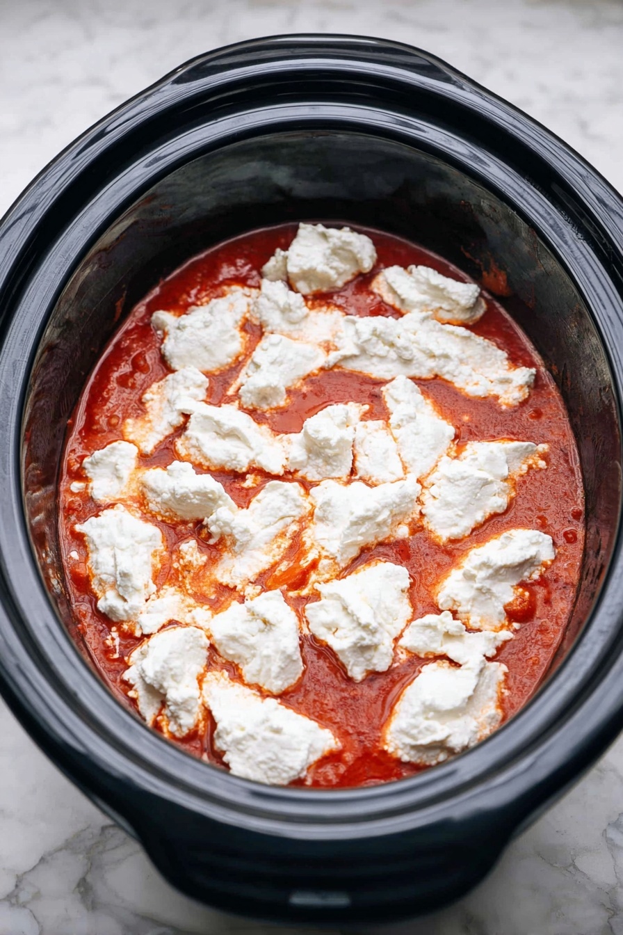 A bowl of pasta with three main layers is shown on a white marbled surface. The first layer is cooked elbow macaroni pasta, pale yellow in color with a smooth texture, filling the bottom of the bowl. The second layer is a chunky brown ground meat sauce mixed with bits of red tomato, spread evenly over the pasta. The third layer is melted cheese, bubbling and creamy white with a slightly browned touch, scattered on top of the sauce. Small green parsley pieces are sprinkled over the entire dish for garnish. A gold spoon rests inside the bowl, partly buried in the pasta mix. The bowl is white with a simple textured finish. Photo taken with an iphone --ar 2:3 --v 7